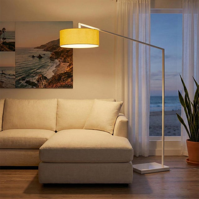 The Stretch Arc Floor Lamp is a modern lighting solution designed by Kirby Groce in 2011. This lamp features a striking...