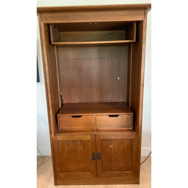 This is a beautiful solid white oak entertainment center manufactured by Stickley. This unit was built in the 1990’s and...