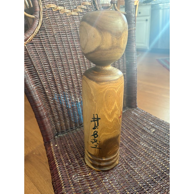 This is a traditional Japanese kokeshi doll. She measures 14 1/4"H and is signed by Inokuchi Hozan. These handmade wooden...