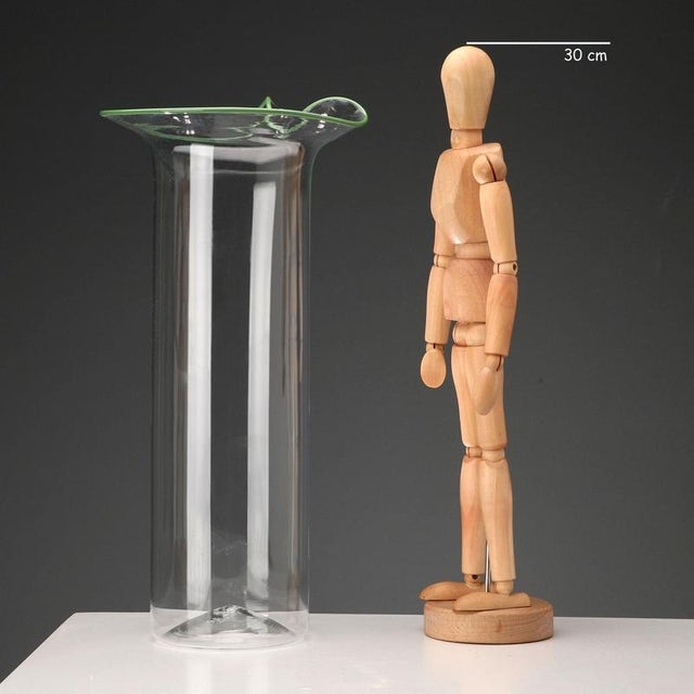 Venini glass vase featuring a transparent cylindrical body topped with a green-lined handkerchief-shaped rim. The...