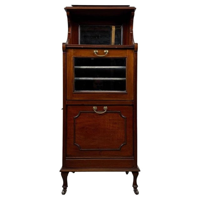 An elegant and exceptionally well-crafted 20th-century mahogany cabinet, distinguished by its unusual combination of...