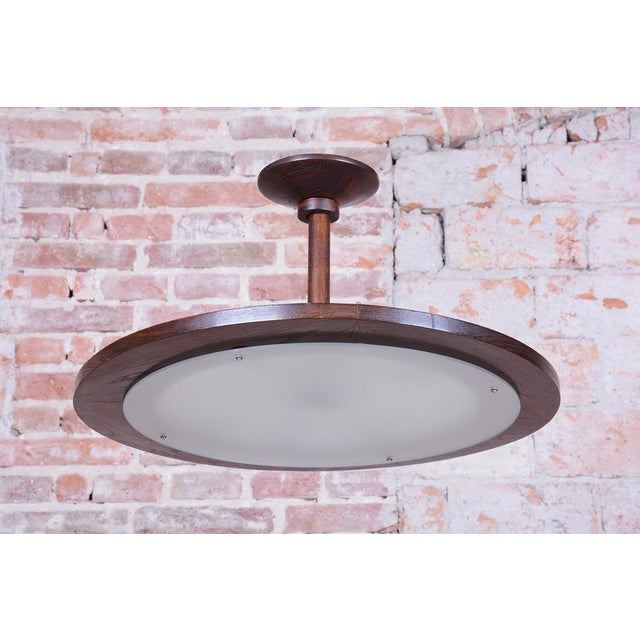 This elegant chandelier represents the clean aesthetic of Czechoslovak design from the mid-20th century, known as Mid-...