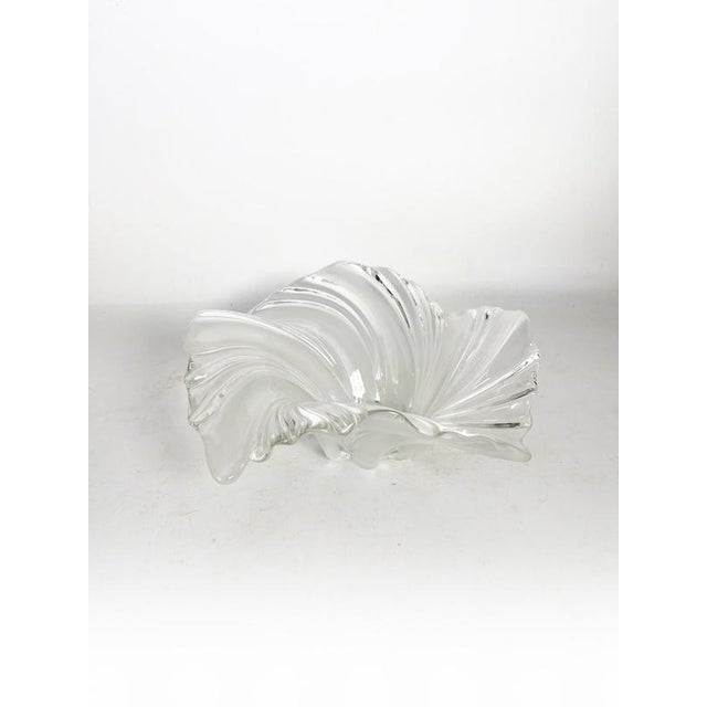 A French crystal trinket dish from the 1970s, with a free-flowing, organic shape reminiscent of a shell or a wave in...