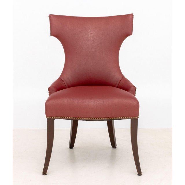 Pair of Contemporary Red Upholstered Lounge Chairs with riveted design on four mahogany legs. 37.5" H x 22" W x 24.5" D;...