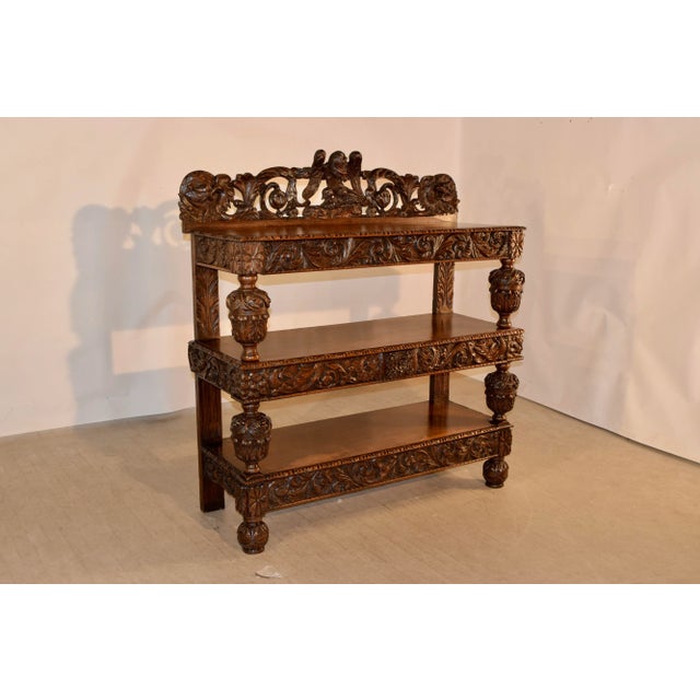 19th century oak dessert buffet from England with wonderfully hand carved decoration. The top has a hand carved and...
