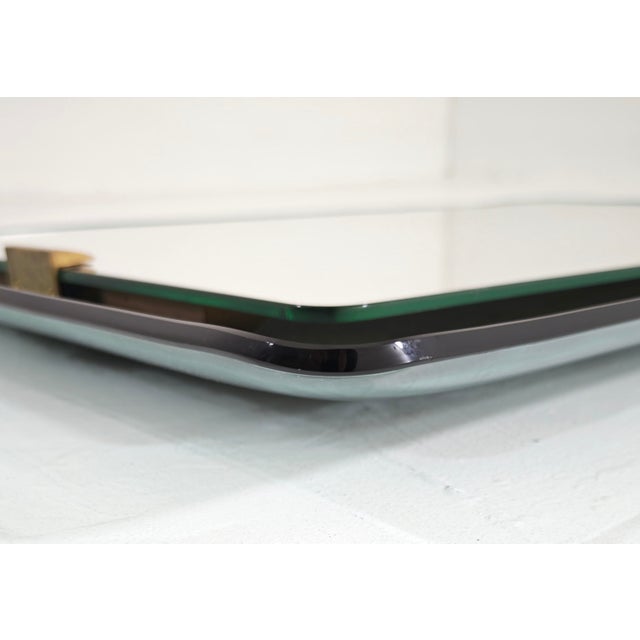 A celebrated piece of historic design, this rare rectangular wall mirror was designed by renowned French designer Max...