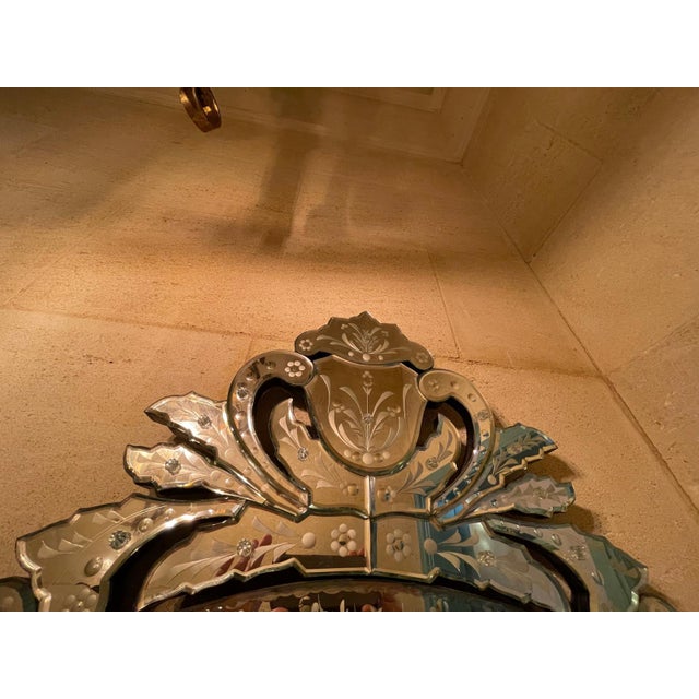 An elegant Venetian-style wall mirror by Maitland-Smith, model 8163-28 Santa Croce, crafted with wheel-engraved and cut...