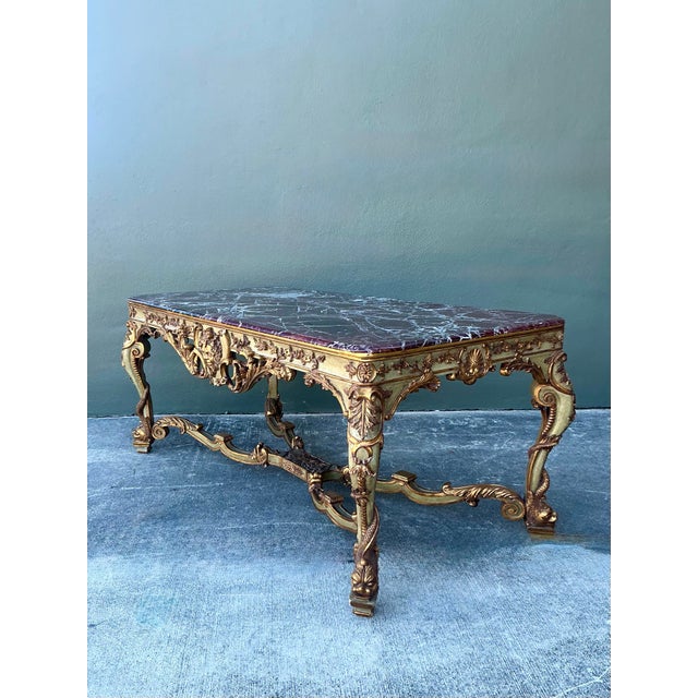 This monumental 19th-century French Rococo console table is a breathtaking showcase of European opulence and artisanal...