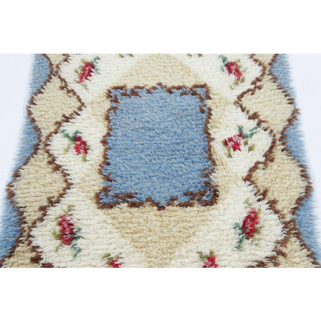 Hand-knotted in lush, high-pile wool in Sweden circa 1960-1970, this 2x4 vintage Swedish Rya rug is a bold new addition to...
