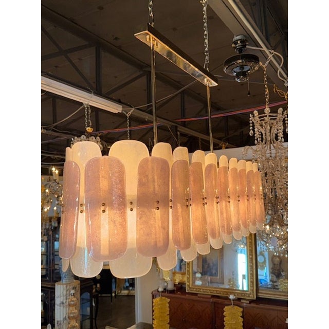 The Modern Frost and Pink Oval Chandelier is a sleek and stylish ceiling fixture that adds a touch of elegance to any...