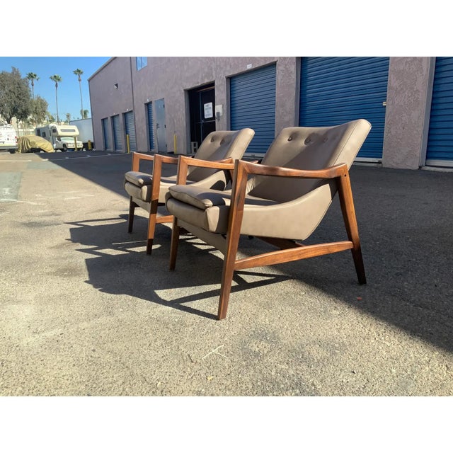 Modern solid walnut modern lounge chairs. In the manner of Kofard Larsen, these chairs are well made. The leather is top...