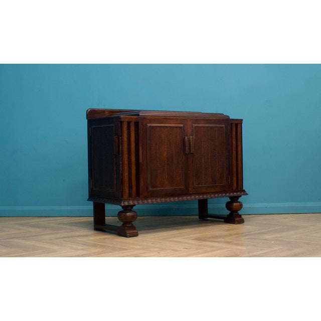 This high-quality oak Art Deco sideboard, circa 1930s. Made by E Gomme ( G Plan) Featuring a cupboard to the front with...