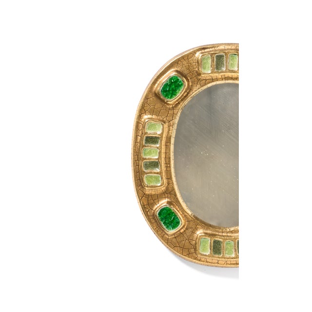 Glazed ceramic mirror with crackled gold and precious green ceramic adornments. The mirror was created by French...