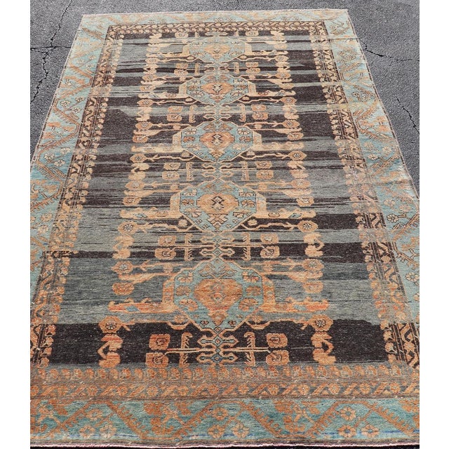 Measures: 5'4 x 9'4 Antique Konya Oushak Rug with Geometric Medallions in Blue, Rust, and Ivory. Keivan Woven Arts /...