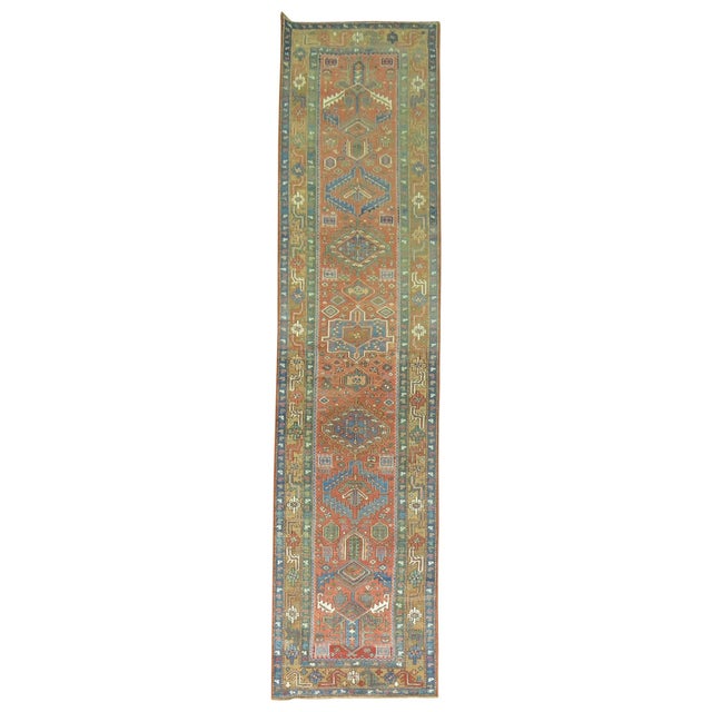 A one of a kind decorative antique Persian Heriz runner. With distinctive large-scale motifs and a wide ranging palette of...