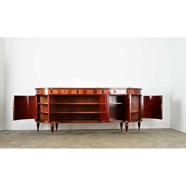 Dimensions: 40 ½” H x 98 ¾” W x 21 ⅝” D A statement piece for a dining room or foyer, this 20th century Louis XVI style...