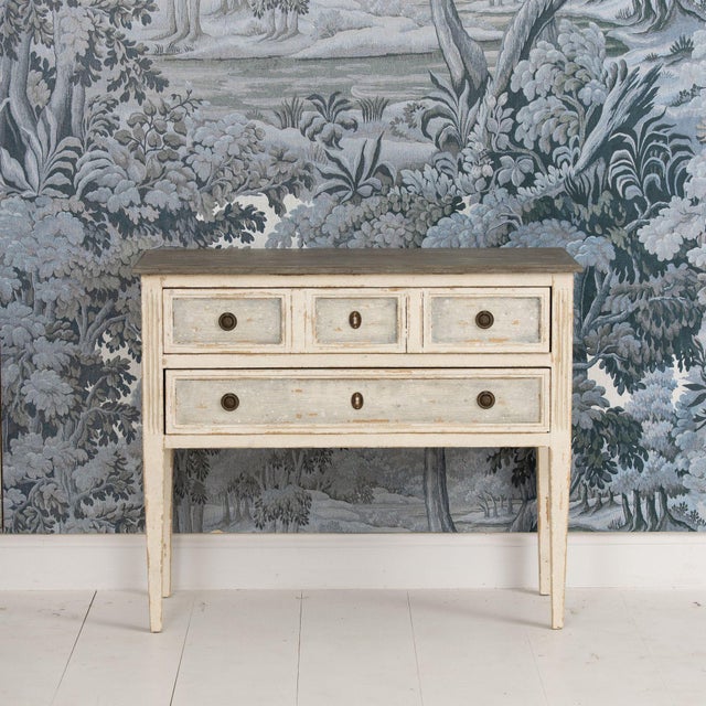A beautiful antique French Louis XVI style painted commode in original paint, standing on elongated tapered legs with...
