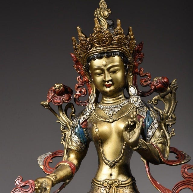 This is a finely crafted antique gilt bronze sculpture of Green Tara, a revered female Bodhisattva in Tibetan Buddhism...