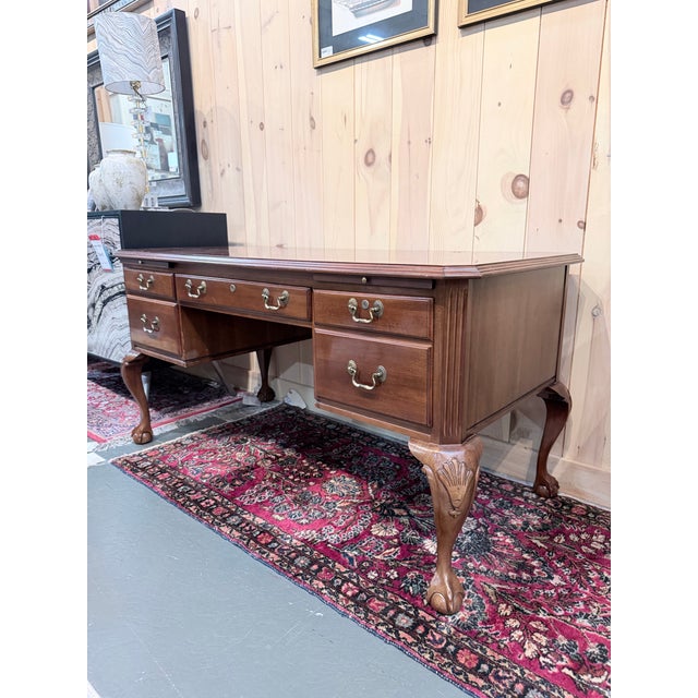 An exceptional Ethan Allen executive desk that embodies the timeless sophistication of traditional Georgian and English-...