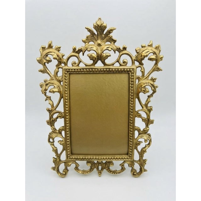 A beautifully detailed vintage tabletop picture frame by Virginia MetalCrafters, with an elaborate Rococo-inspired...