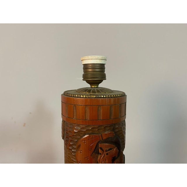 A striking Japanese carved bamboo lamp base featuring a finely executed relief of a traditional samurai warrior. The...