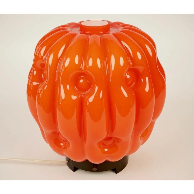 The stylised opaline glass pumpkin lamp is from the 1960s. The glass is attached to a bakelite base with three set screws...