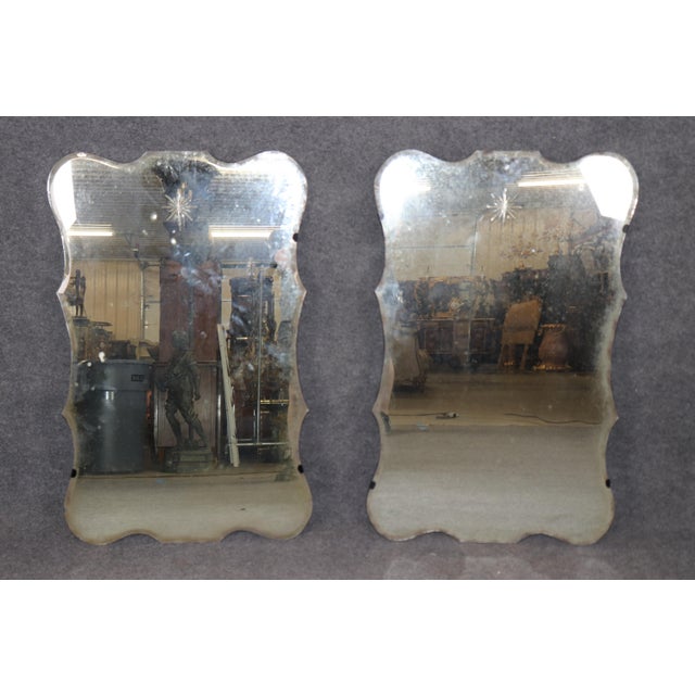 This pair of Maison Jansen style mirrors exudes timeless elegance with their sophisticated design and aged patina finish....