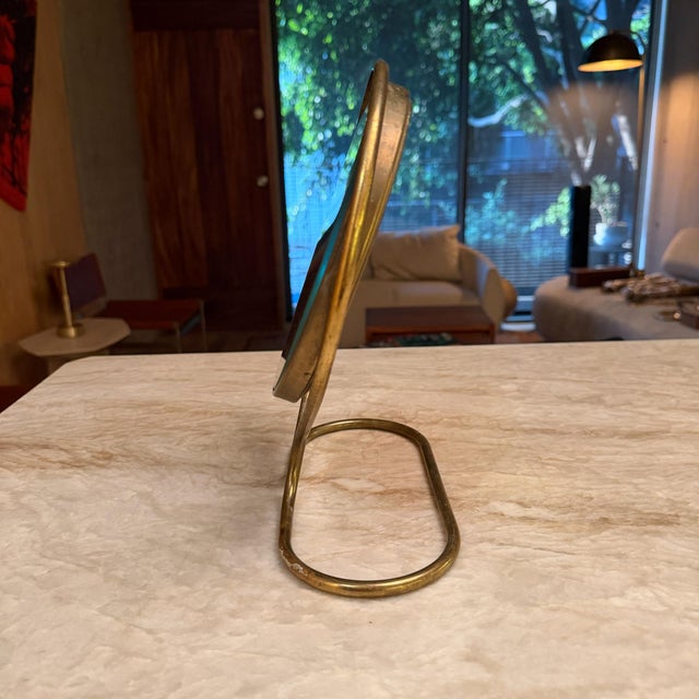 For your consideration, a vintage brass swivel vanity mirror, often featuring a design reminiscent of the mid-century...