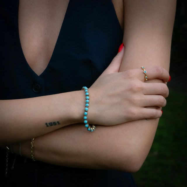 Enhance your jewelry collection with the timeless Minimalist Turquoise Stone & Gold Stackable Adjustable Ring. Crafted...