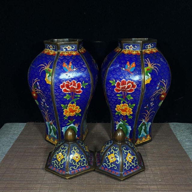 A beautiful pair of Chinese Cloisonné Enamel "General Jars." These vibrant vessels feature a faceted, hexagonal shape. The...