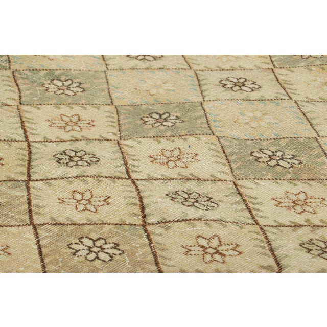 Made with hand-knotted wool and originating from Turkey circa 1960-1970, this 6x9 vintage rug is an exciting new piece in...