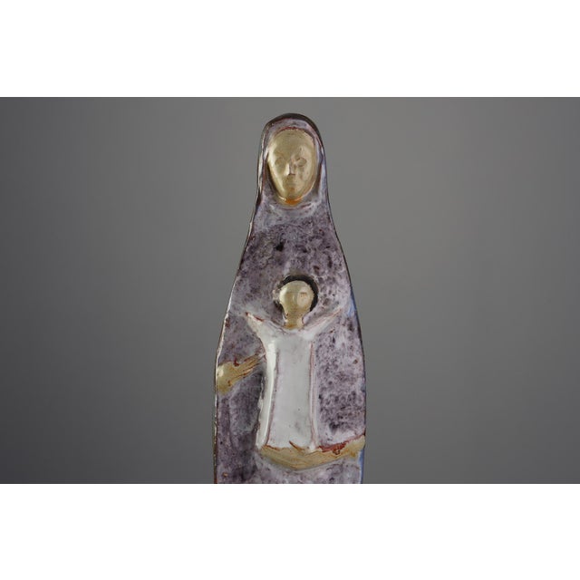A serene and deeply expressive example of Belgian mid‑century ceramic art, this 1960 sculpture of a mother with the Child...