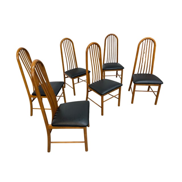 Elevate your dining space with this striking set of six vintage Danish Modern teak spindle back dining chairs, crafted...