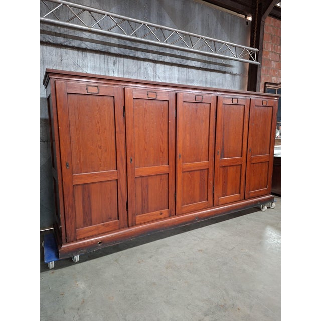 Large vintage wooden laboratory cabinet from Berlin, featuring 52 spacious drawers concealed behind doors. Originally used...
