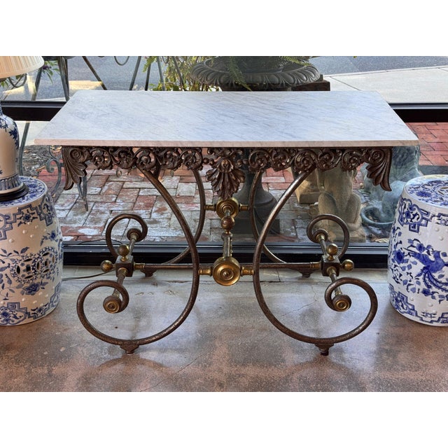 French 19th century pastry table, white marble top over a pierced iron apron of scrolling foliage and rosettes with a...