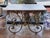 French 19th century pastry table, white marble top over a pierced iron apron of scrolling foliage and rosettes with a...