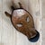 A striking vintage hand-carved wooden zebra mask featuring bold graphic striping and an elongated sculptural form. Crafted...