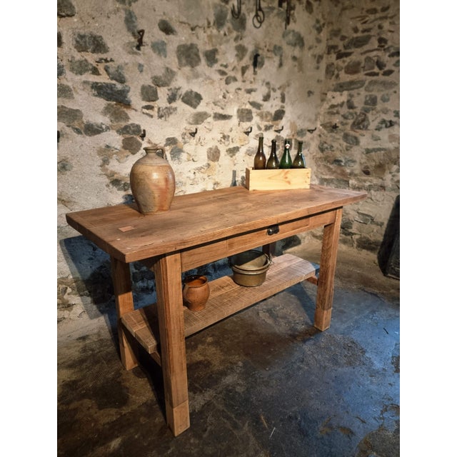 This authentic French oak workbench from the 1930s combines utilitarian design with timeless material quality. Originally...