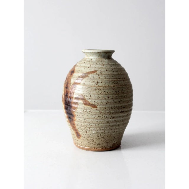A vintage studio pottery vase, hand-crafted and signed by the artist. The distinctive beehive-form vessel features a...