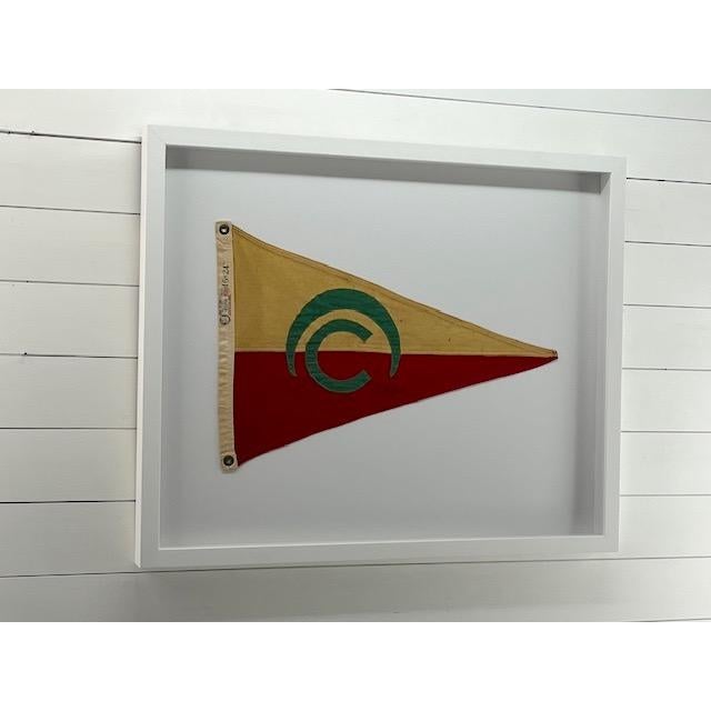 Framed nautical pennant with a circular design. Very colorful and fun for any nautical decor. Professionally famed in a...