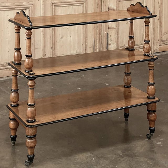 Charming and practical antique English open library caddy, designed for the cultivated interiors of the late Victorian and...