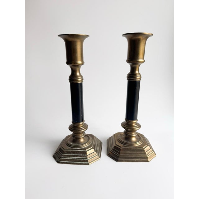 Beautiful vintage pair of solid brass candlesticks featuring elegant black columns and stepped octagonal bases. The...