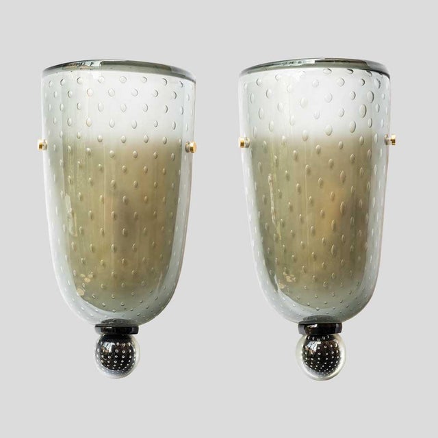 Pair of wall lights, hand blown smoke grey colour glass with bubbles ” Bullicante “, gold color enamelled metal holder...