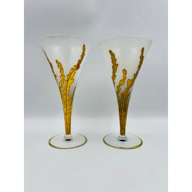 Elegant and sculptural, this pair of vintage wine flutes features a beautifully frosted bowl accented by striking relief-...