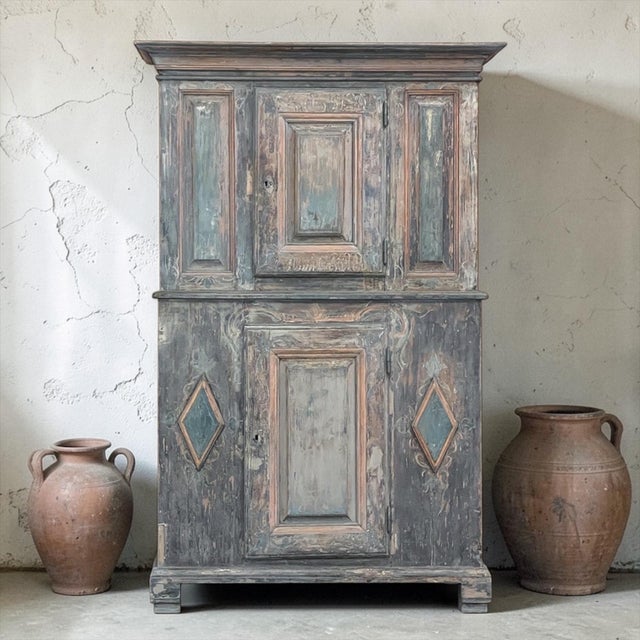 18th Century Swedish Painted Pine Two-Tiered Cabinet is ideal for the casual decor, providing both visual impact and...