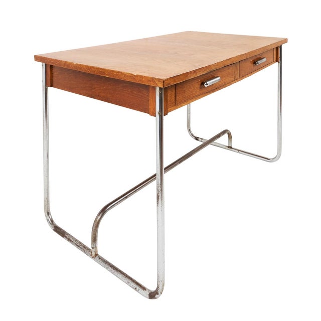 Discovered in France, this midcentury desk features a beautiful figured-oak top, two drawers and tubular metal legs. Made...