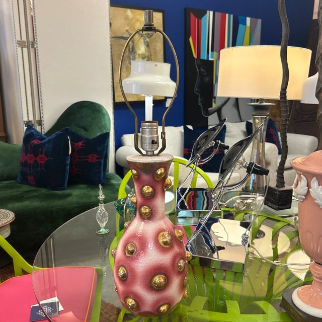 Pink, white, and gold porcelain ceramic lamp. It has decorative gold balls that are part of the design.