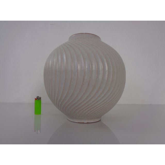 Large, round ceramic vase with wave decoration by Carstens Tönnieshof from the late 1960s. This piece has an attribution...