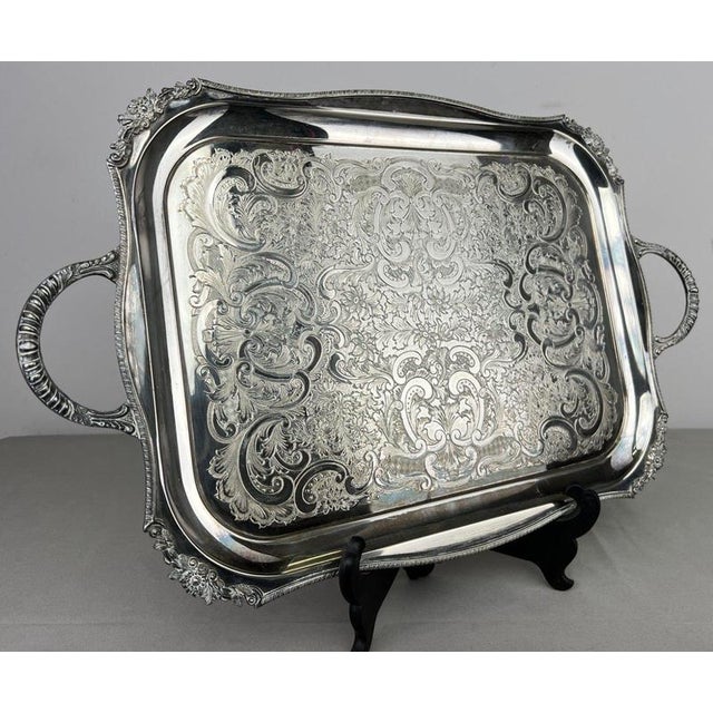 A decorative Vintage English serving tray featuring an elaborate engraved floral and scrolling design across the centre,...