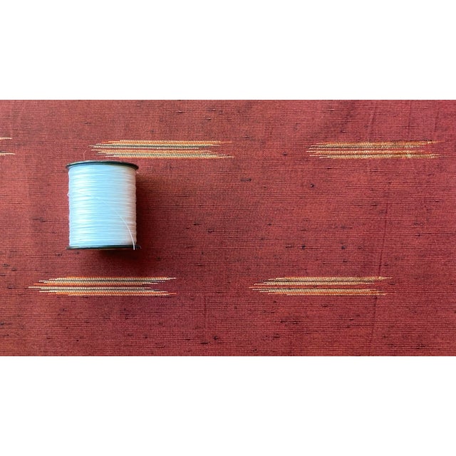 Vintage red raw silk 14 in x 13 yards has a shine to it and reflects the light beautifully accents of gold and black...